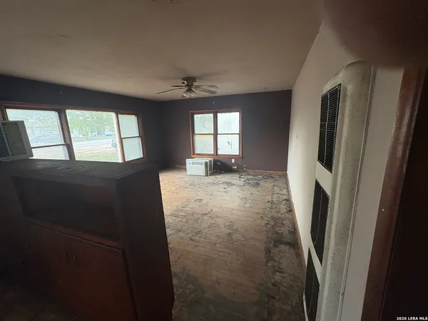 a view of hallway with window and a fireplace