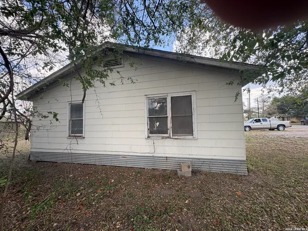 a side view of a house with a yard