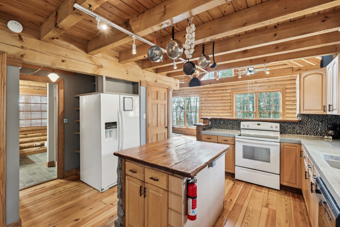 1140 Leatherwood Road White Bluff, TN 37187 - Photo 11 of 29 a kitchen with a stove a refrigerator and wooden floor