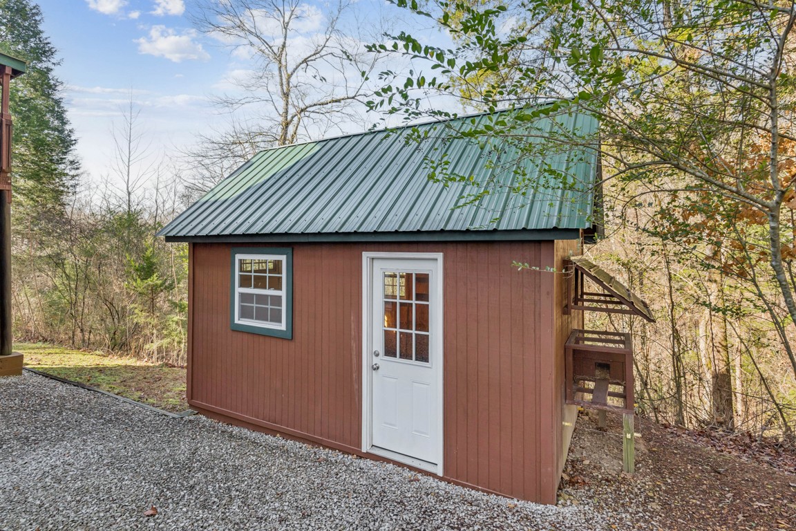 1140 Leatherwood Road White Bluff, TN 37187 - Photo 25 of 29 a front view of a house with garden