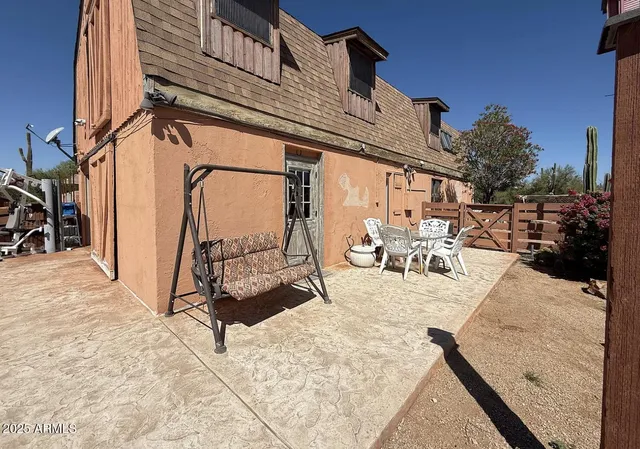 a view of a patio with dining table and chairs