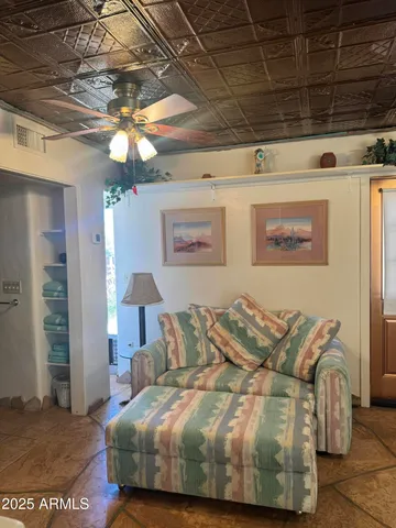 a spacious bedroom with a bed and a chandelier
