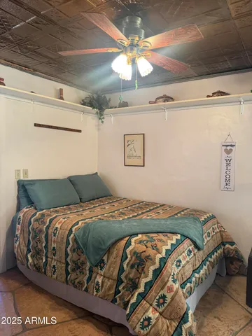 a bedroom with a bed and a chandelier