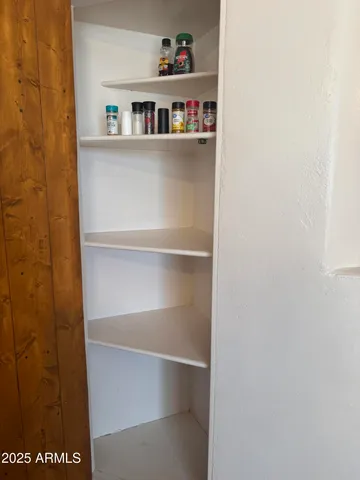 a shelf with books and knick knacks on it