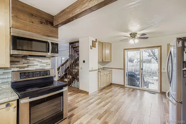 a kitchen with stainless steel appliances a stove microwave and a refrigerator