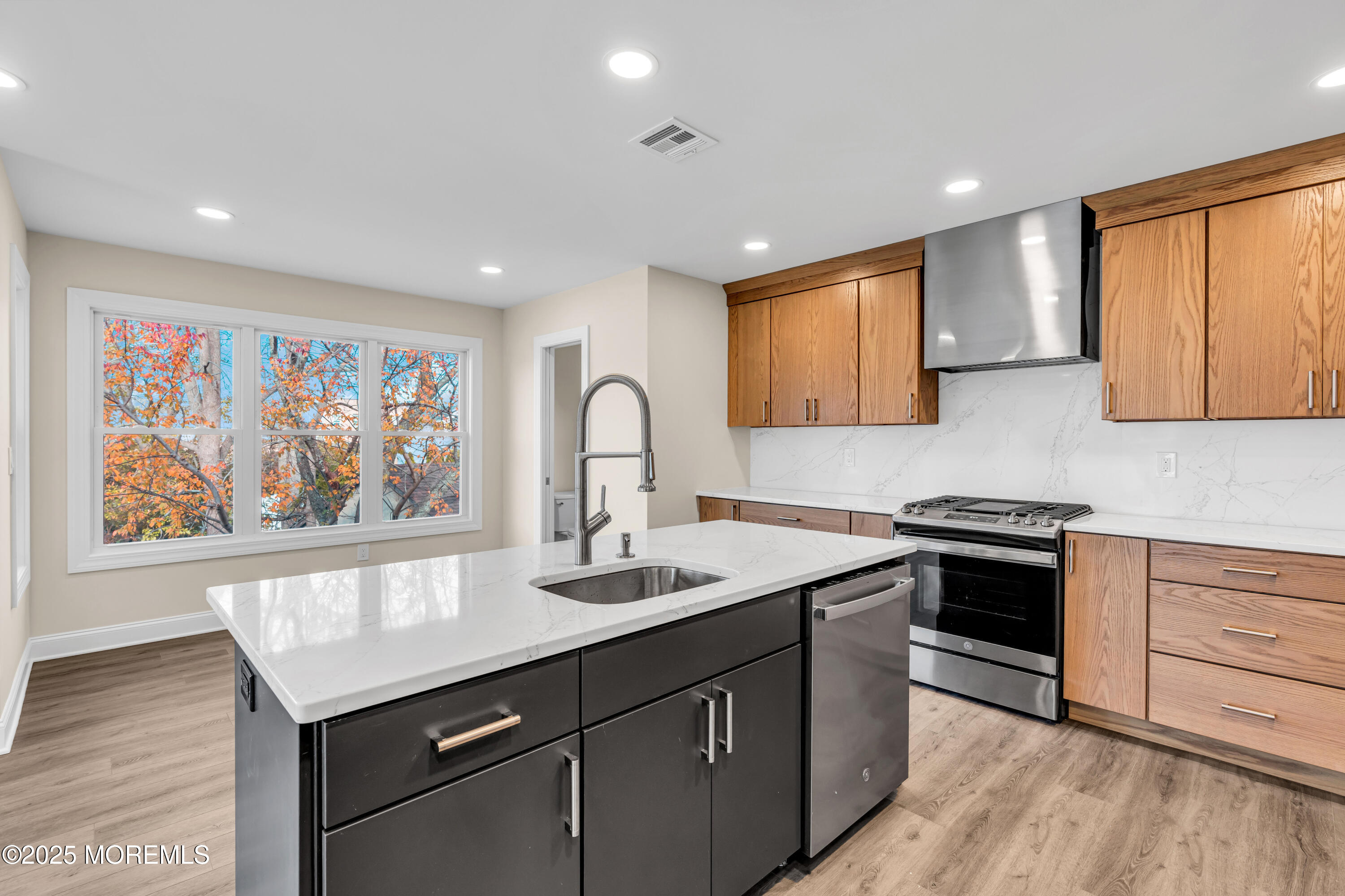 1900 Main Street Belmar, NJ 07719 - Photo 9 of 20 a kitchen with stainless steel appliances granite countertop a stove a sink and a microwave
