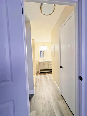 a view of a hallway and wooden floor