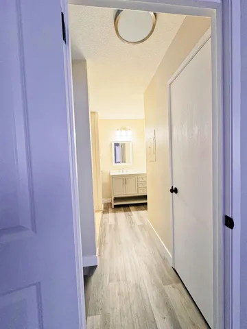 a view of a hallway and wooden floor