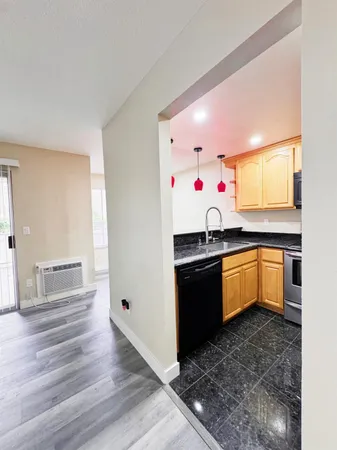 a kitchen with granite countertop a sink and cabinets