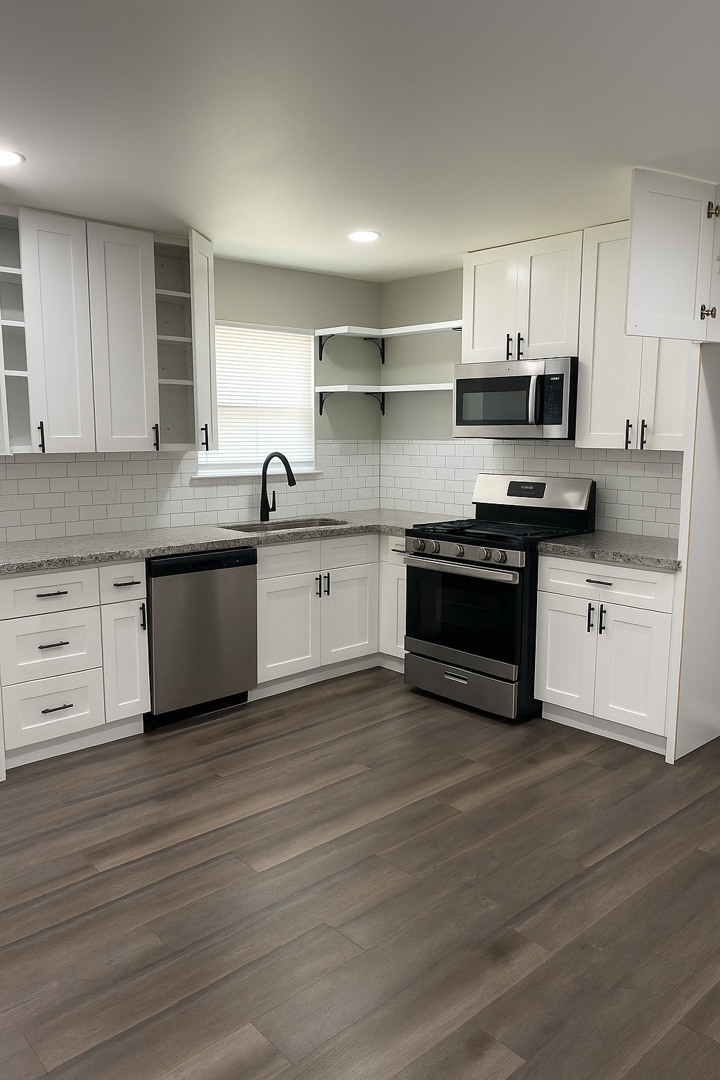 7317 Briefway Street, Unit B Houston, TX 77087 - Photo 3 of 13 a kitchen with stainless steel appliances granite countertop a stove top oven a sink and white cabinets