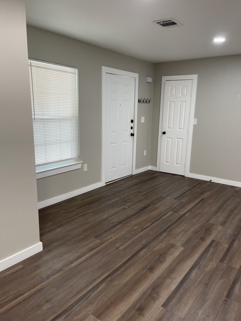 7317 Briefway Street, Unit B Houston, TX 77087 - Photo 5 of 13 an empty room with wooden floor and windows