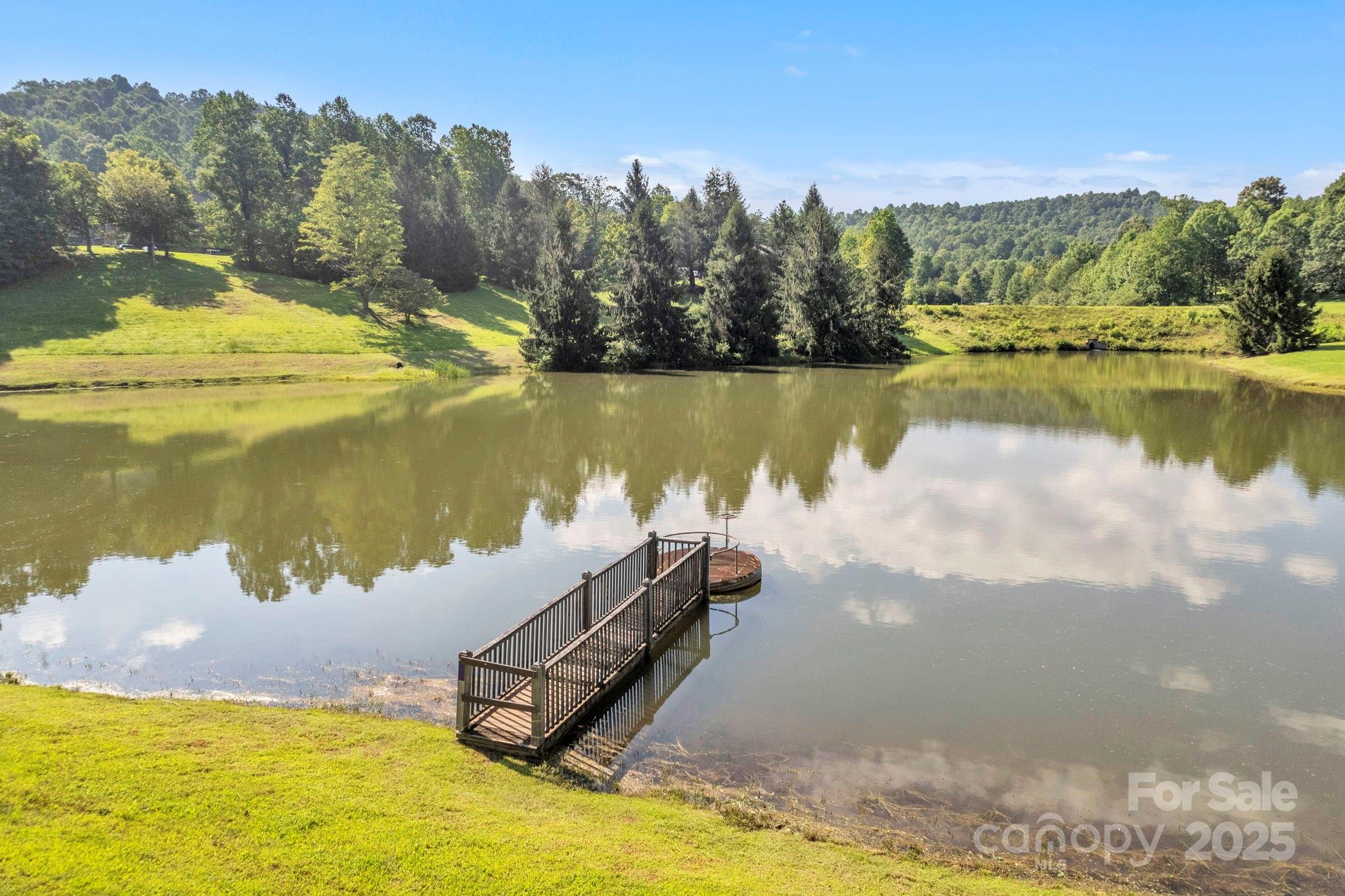 Lot 12 Sunset Ridge Drive, Unit LOT 12 Columbus, NC 28722 - Photo 6 of 10 a view of a lake in between two and trees