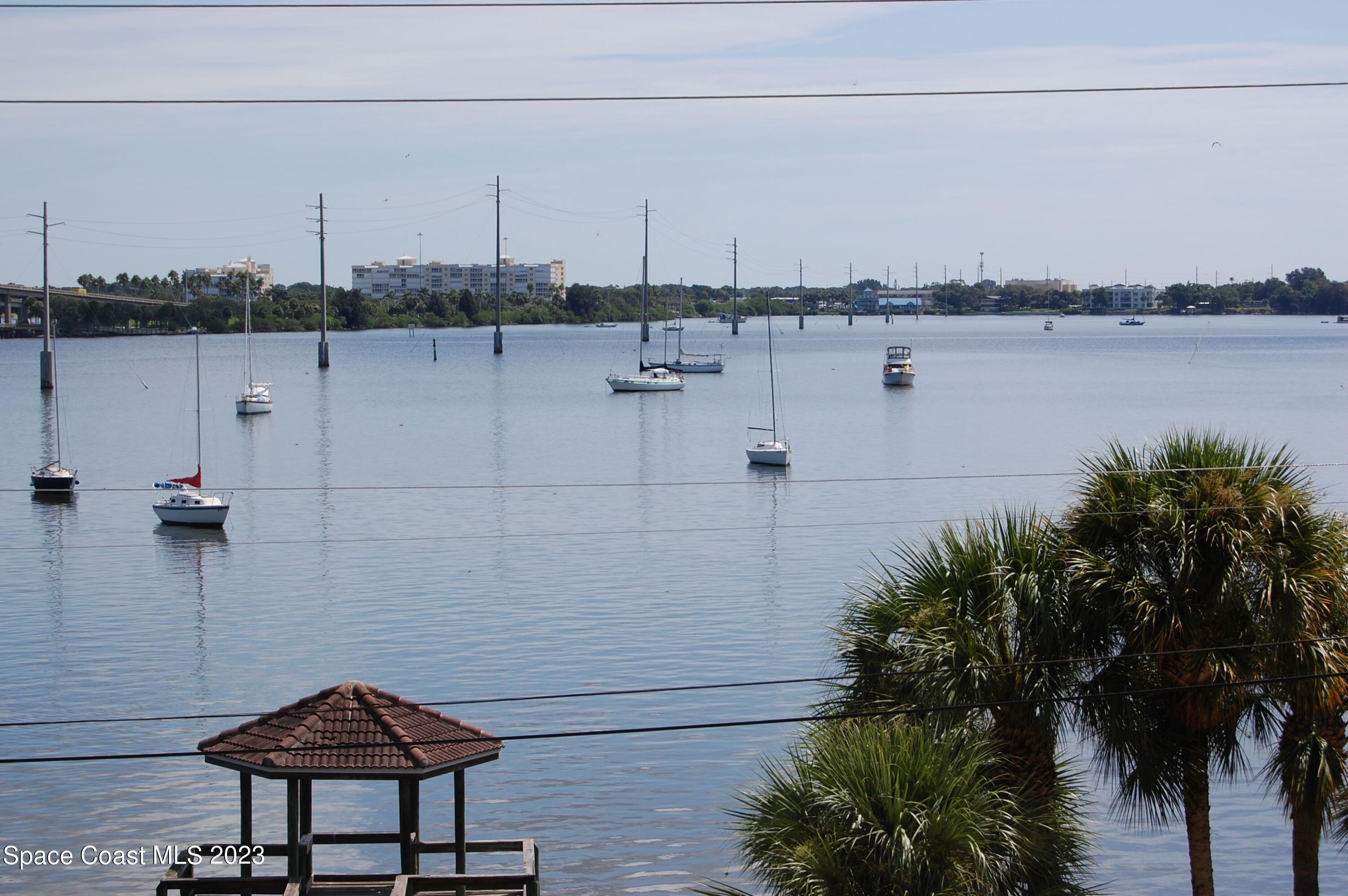29 Riverside Drive, Unit 302 Cocoa, FL 32922 - Photo 1 of 56 a view of a lake with boats and trees in the background