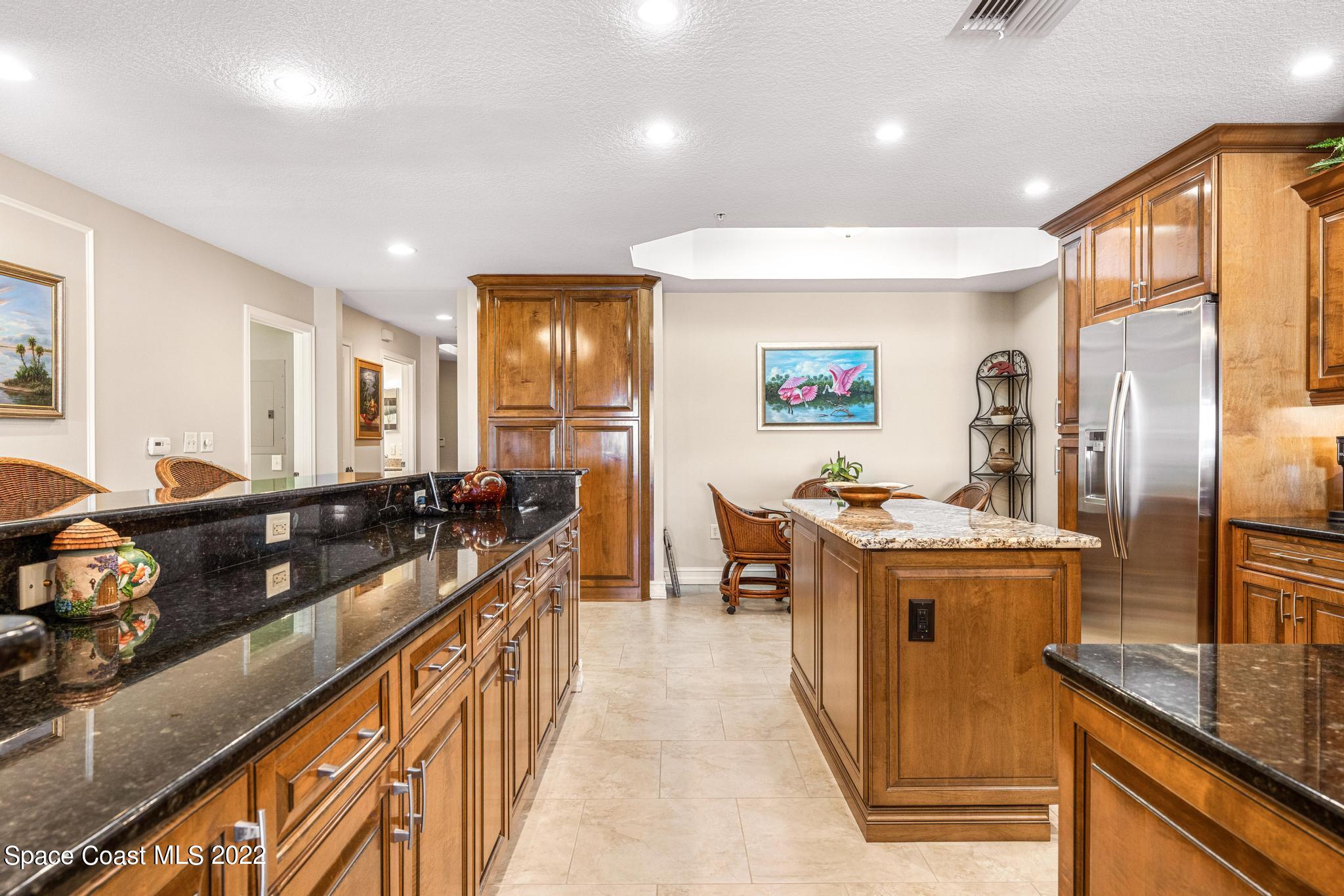 29 Riverside Drive, Unit 302 Cocoa, FL 32922 - Photo 11 of 56 a kitchen with stainless steel appliances granite countertop a stove and a refrigerator