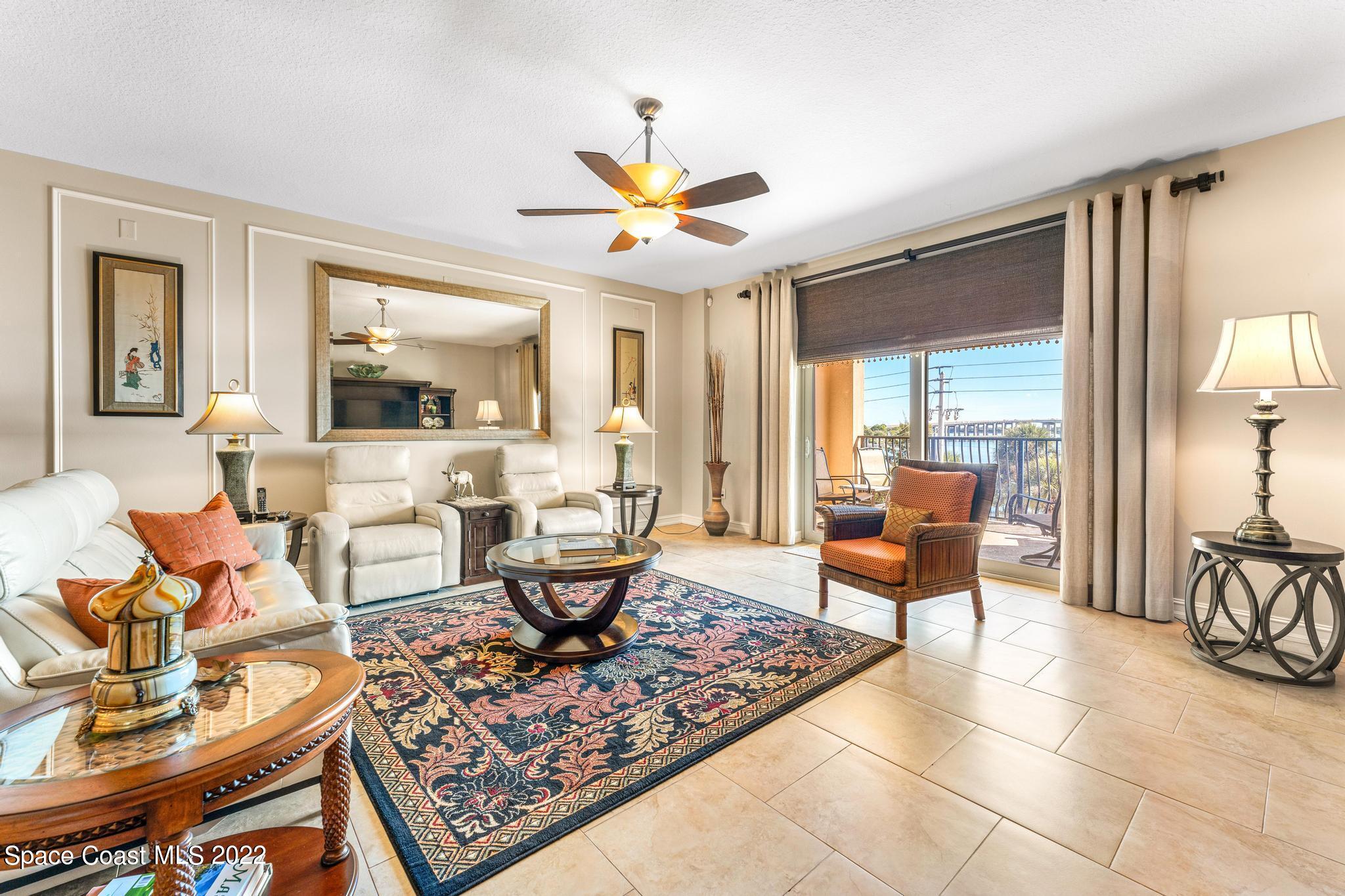 29 Riverside Drive, Unit 302 Cocoa, FL 32922 - Photo 18 of 56 a living room with furniture a table and a large window