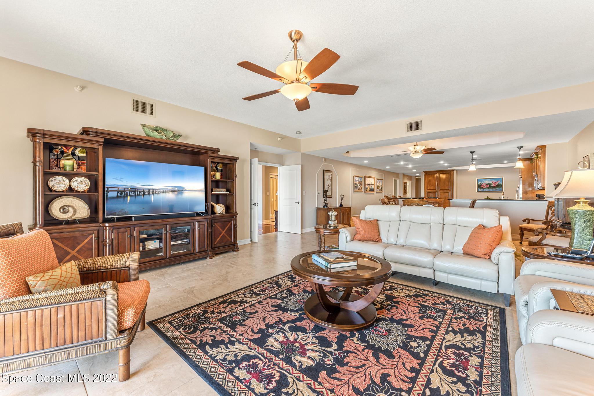 29 Riverside Drive, Unit 302 Cocoa, FL 32922 - Photo 20 of 56 a living room with furniture and a flat screen tv