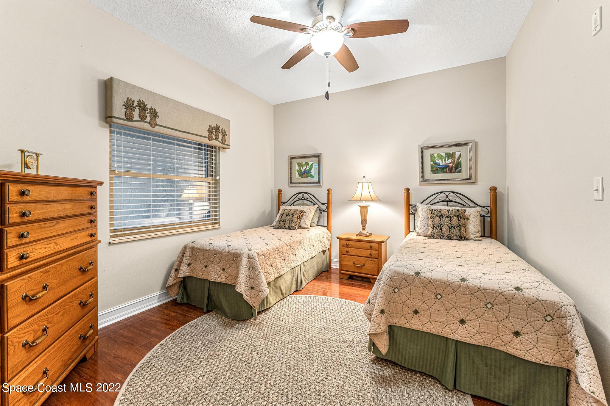 29 Riverside Drive, Unit 302 Cocoa, FL 32922 - Photo 21 of 56 a bedroom with two beds and painting on the wall