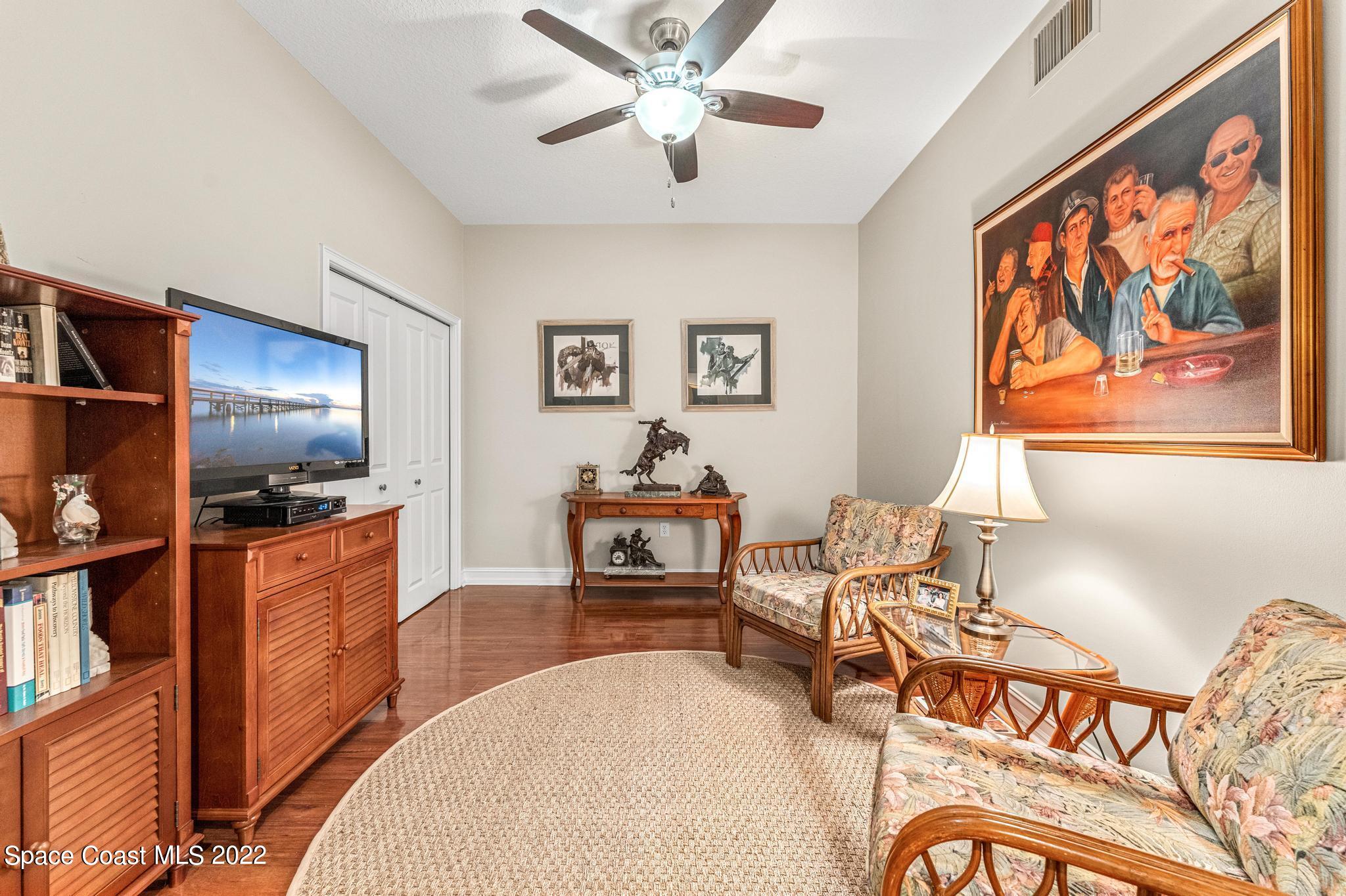 29 Riverside Drive, Unit 302 Cocoa, FL 32922 - Photo 23 of 56 a living room with furniture and a flat screen tv