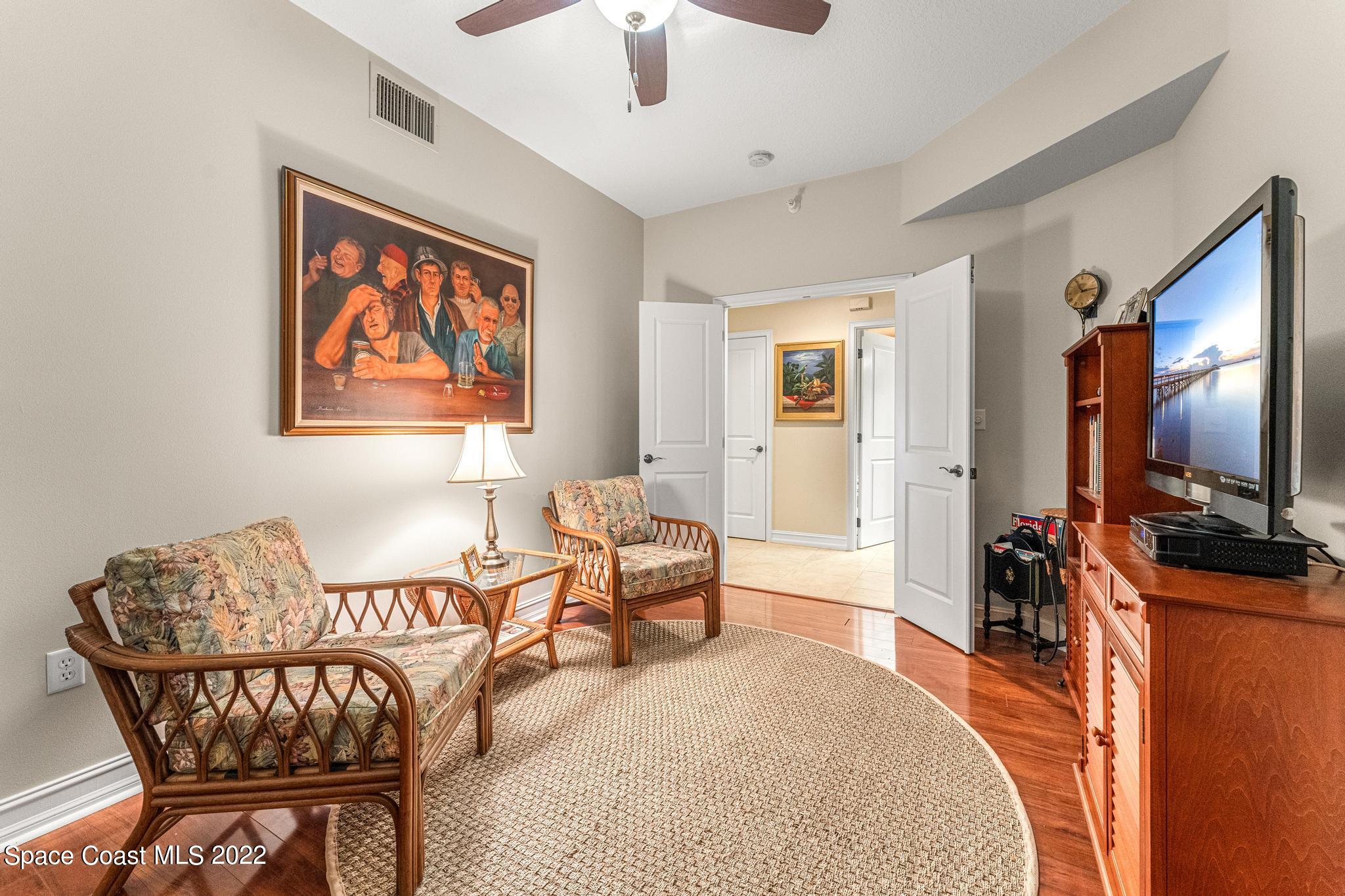 29 Riverside Drive, Unit 302 Cocoa, FL 32922 - Photo 24 of 56 a bedroom with furniture and a flat screen tv