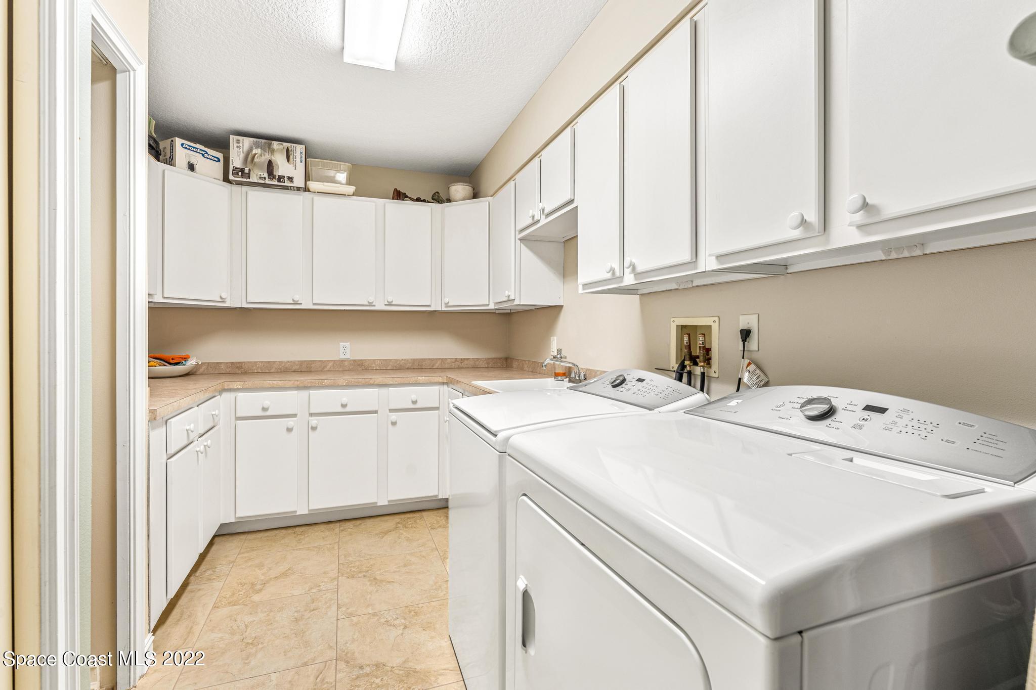 29 Riverside Drive, Unit 302 Cocoa, FL 32922 - Photo 26 of 56 a kitchen with cabinets appliances a sink and a window