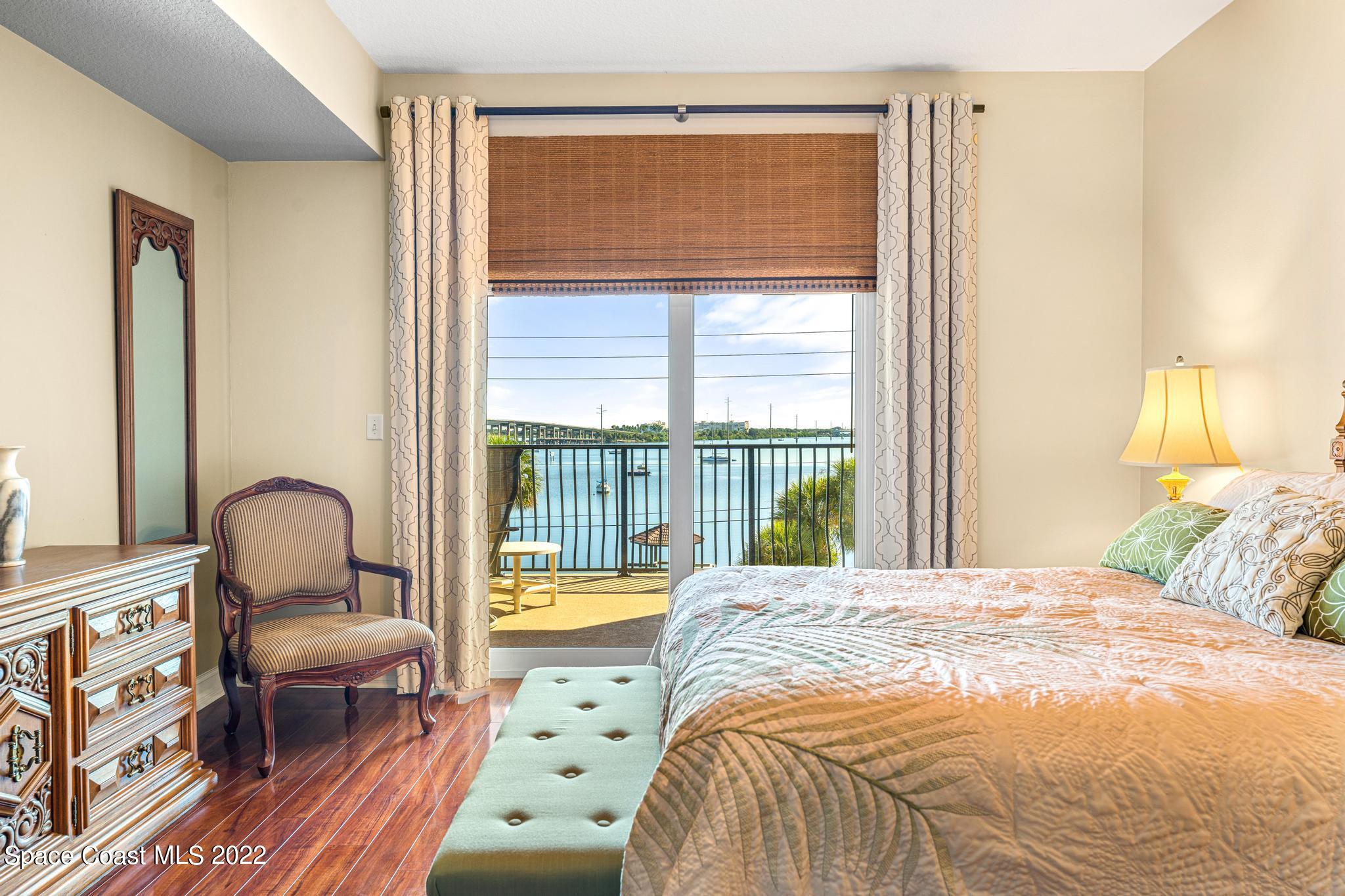 29 Riverside Drive, Unit 302 Cocoa, FL 32922 - Photo 30 of 56 a bedroom with a bed and a large window