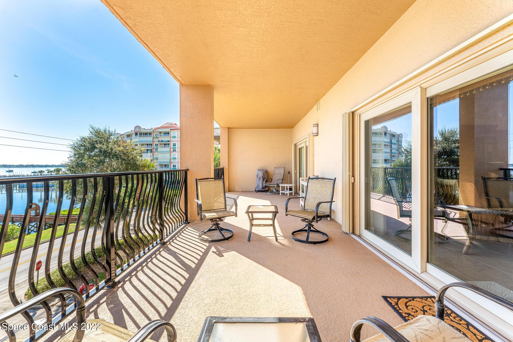 29 Riverside Drive, Unit 302 Cocoa, FL 32922 - Photo 35 of 56 a view of balcony with chairs and wooden fence
