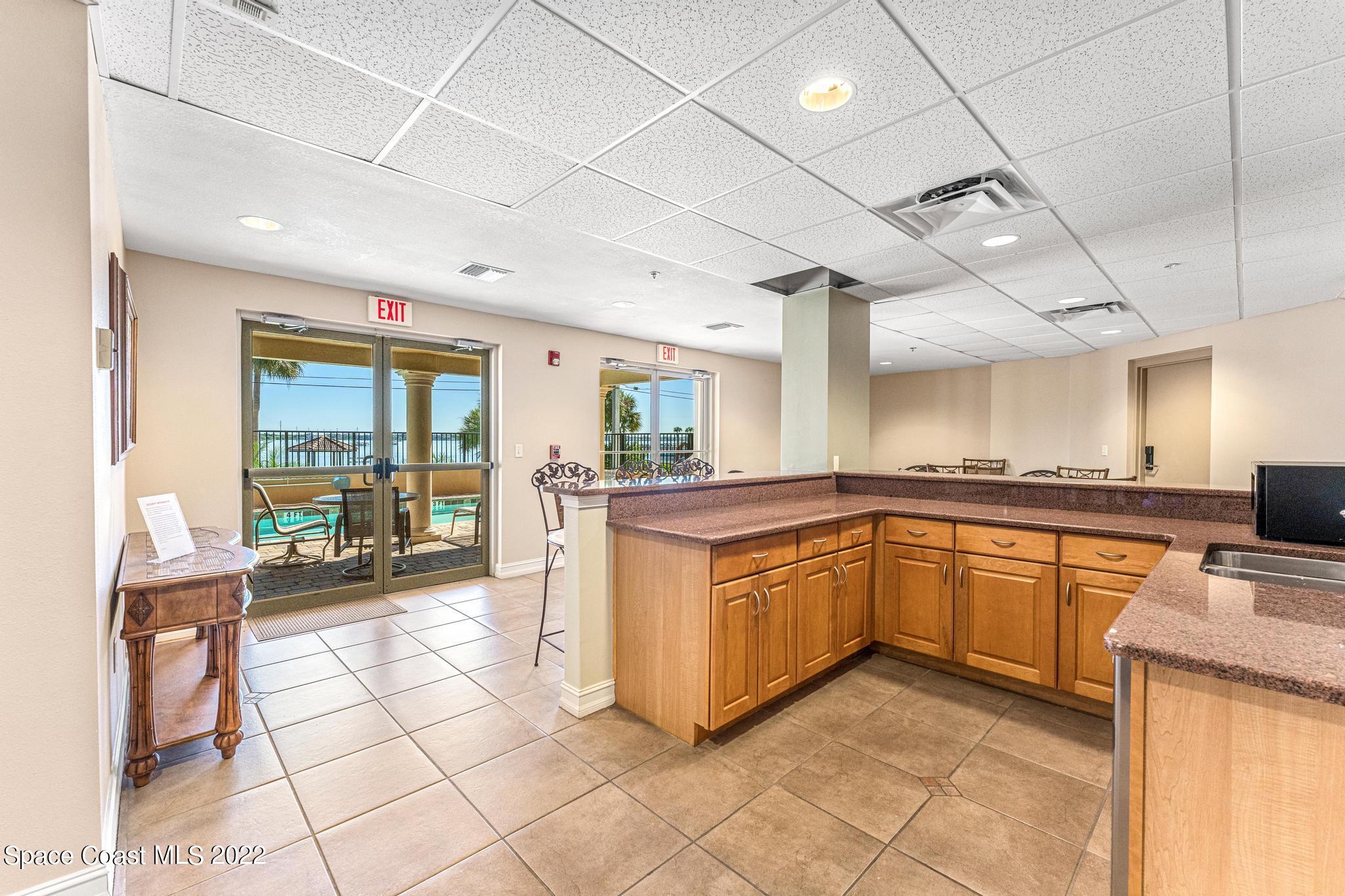 29 Riverside Drive, Unit 302 Cocoa, FL 32922 - Photo 43 of 56 a large kitchen with stainless steel appliances granite countertop a stove and cabinets