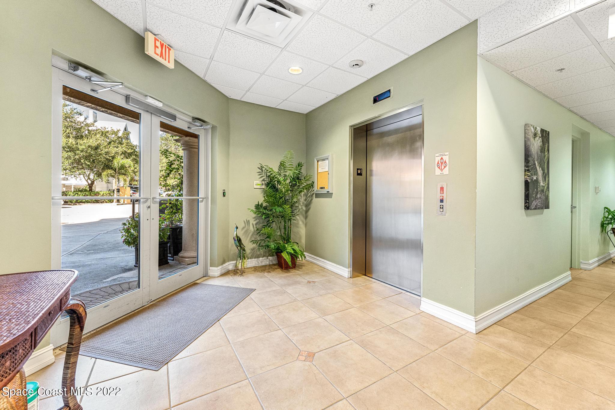 29 Riverside Drive, Unit 302 Cocoa, FL 32922 - Photo 44 of 56 a view of a hallway with wooden floor and windows