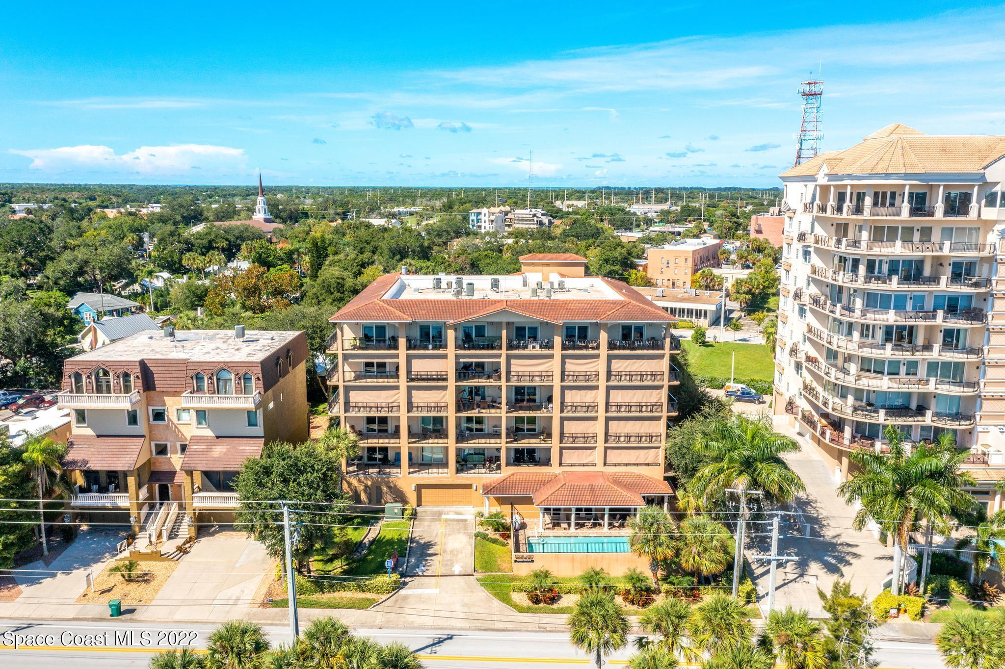 29 Riverside Drive, Unit 302 Cocoa, FL 32922 - Photo 50 of 56 a front view of a building with a garden