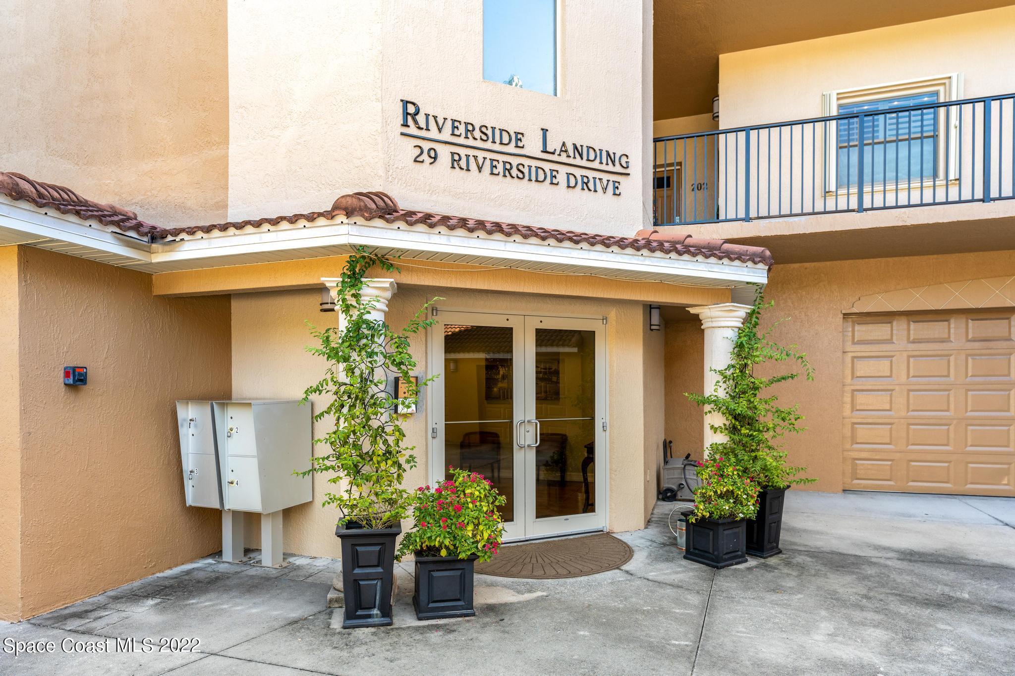 29 Riverside Drive, Unit 302 Cocoa, FL 32922 - Photo 5 of 56 a front view of a building with potted plants