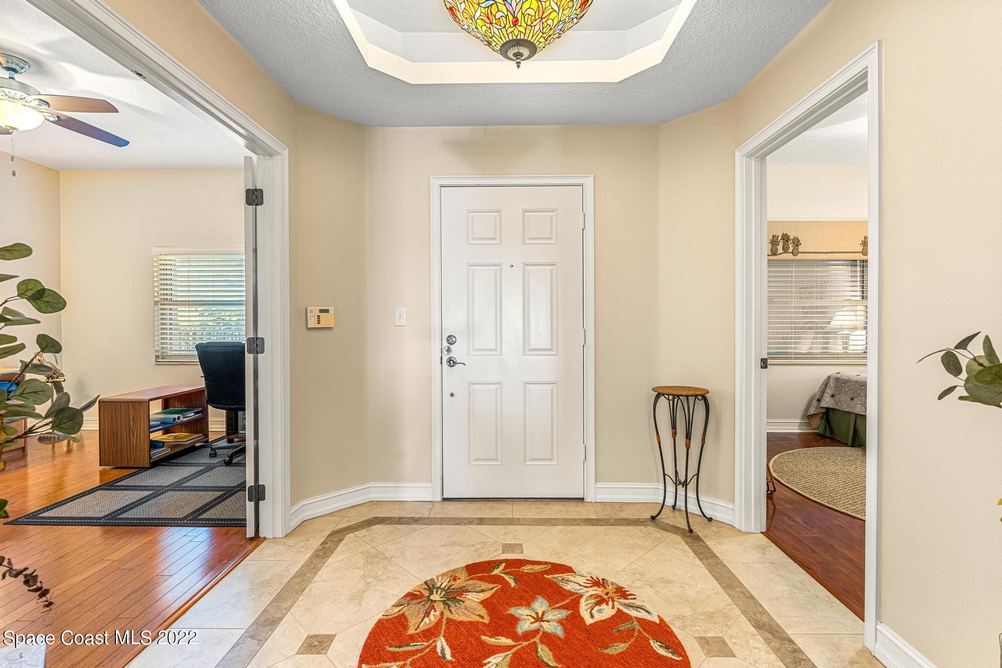 29 Riverside Drive, Unit 302 Cocoa, FL 32922 - Photo 8 of 56 a view of a bedroom with wooden floor and a bathroom