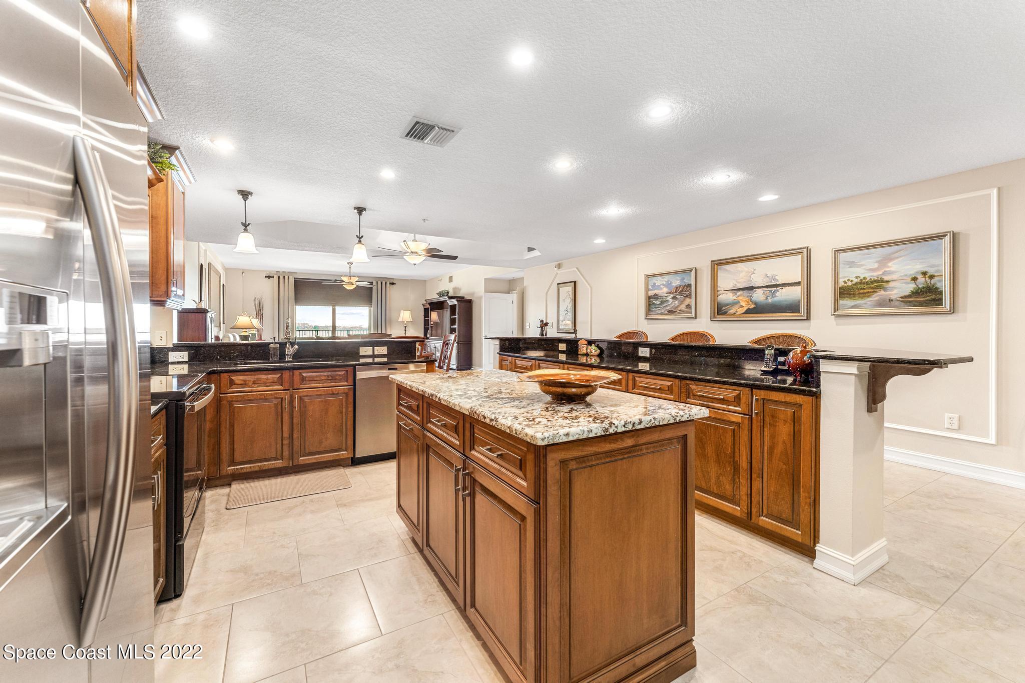 29 Riverside Drive, Unit 302 Cocoa, FL 32922 - Photo 10 of 56 a kitchen with stainless steel appliances granite countertop a sink and cabinets