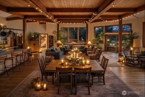 a living room with stainless steel appliances furniture and a large window