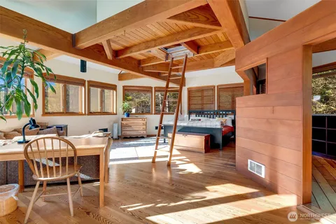 a spacious bedroom with a bed and a large window