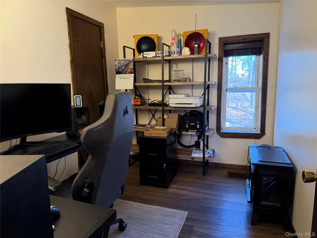 a view of a workspace with furniture and a flat screen tv