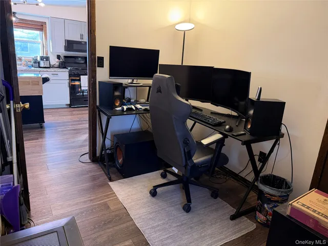 a bedroom with a bed and a flat tv screen on a dresser