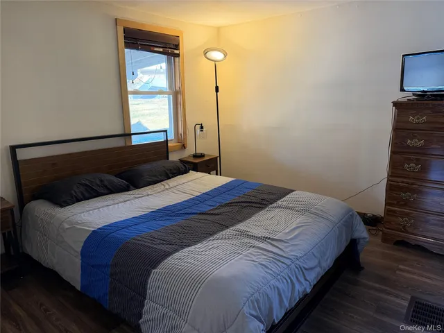 a bed sitting in a bedroom next to a window