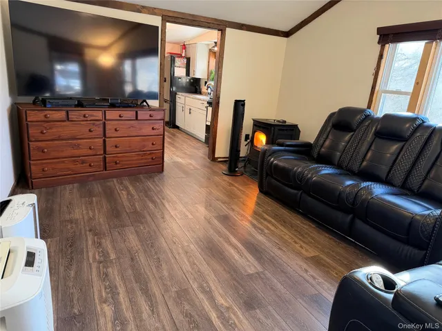 a view of a hallway with wooden floor and windows