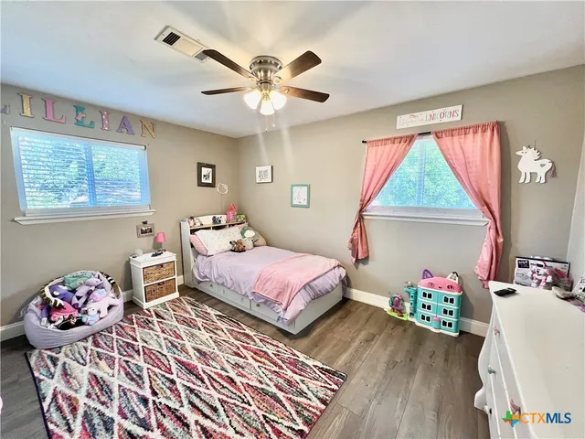 a bedroom with bed and a chandelier