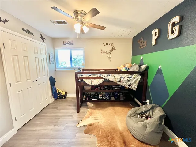 a bedroom with furniture and a wooden floor