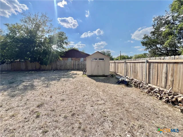 a backyard of a house with table and chairs