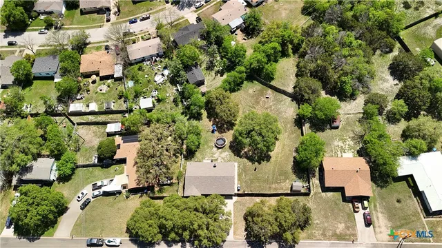 an aerial view of a houses with yard