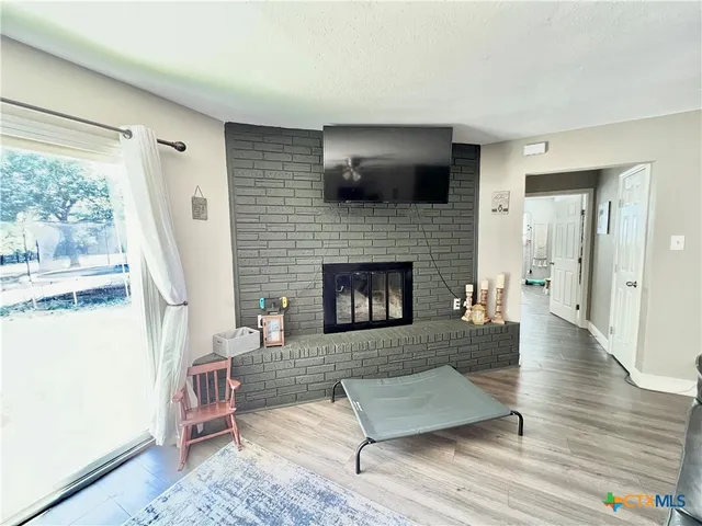 a living room with furniture flat screen tv and a fireplace