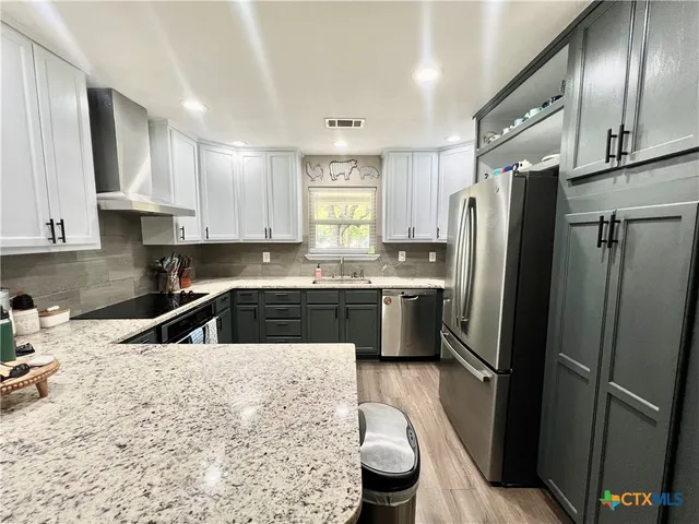 a kitchen with a refrigerator sink and stove