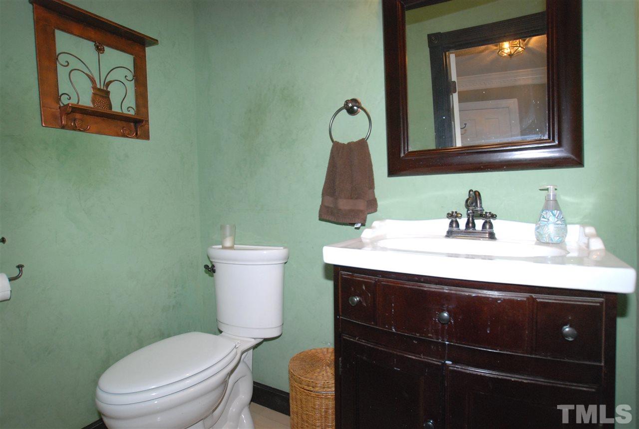 3313 Horseshoe Bend Raleigh, NC 27613 - Photo 14 of 25 a bathroom with a toilet sink and mirror