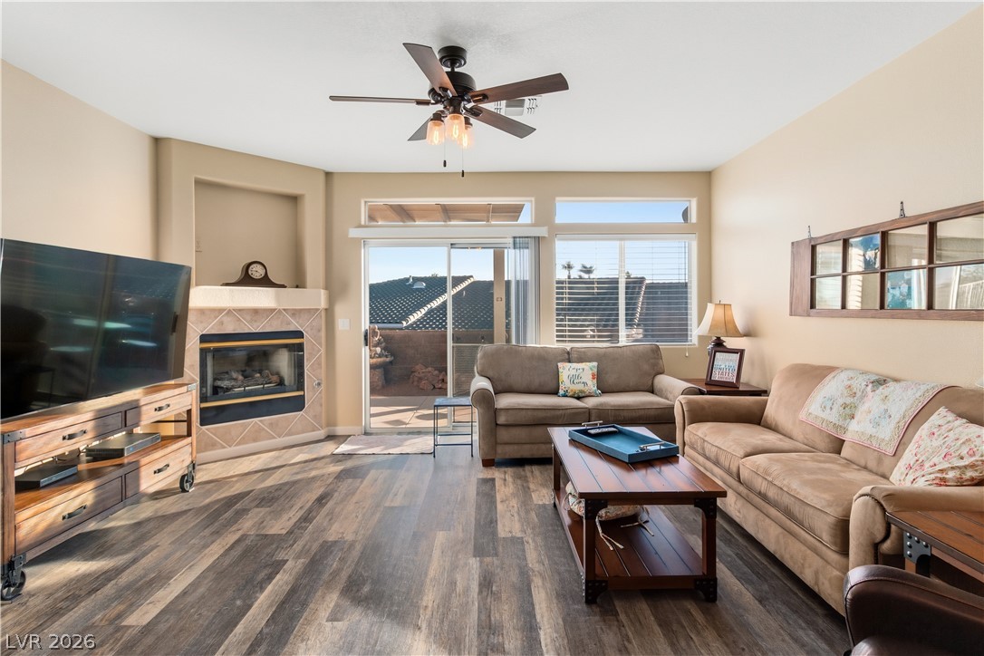 3350 Pheasant Canyon Way, Unit 1008 Laughlin, NV 89029 - Photo 12 of 80 Living area with dark wood-style floors, a fireplace, and ceiling fan