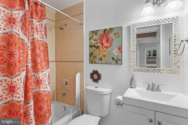 a bathroom with a toilet a sink and a mirror