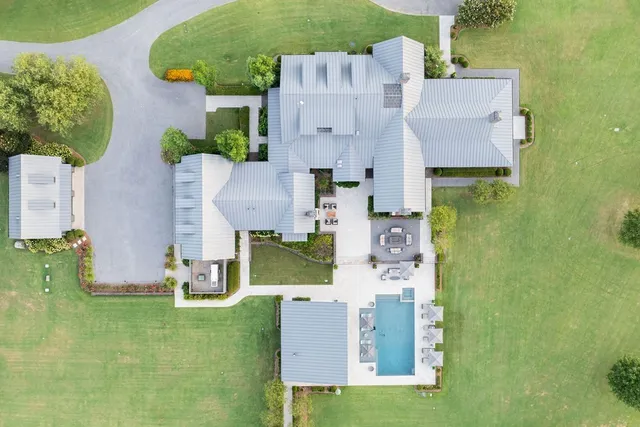 a living room with a fireplace and a floor to ceiling window