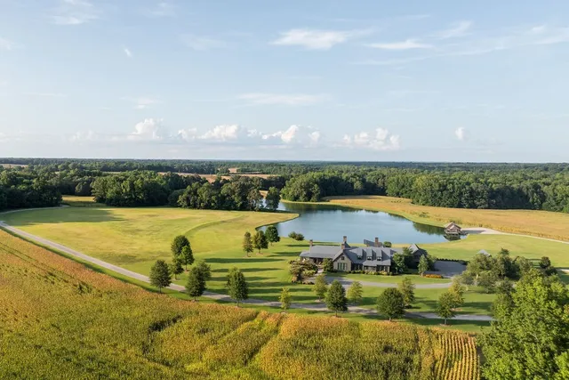 a view of swimming pool with a table and chairs under an umbrella