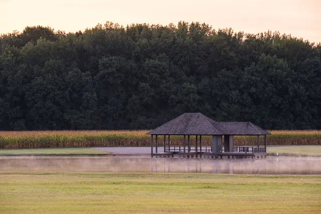 a view of a house next to a big yard